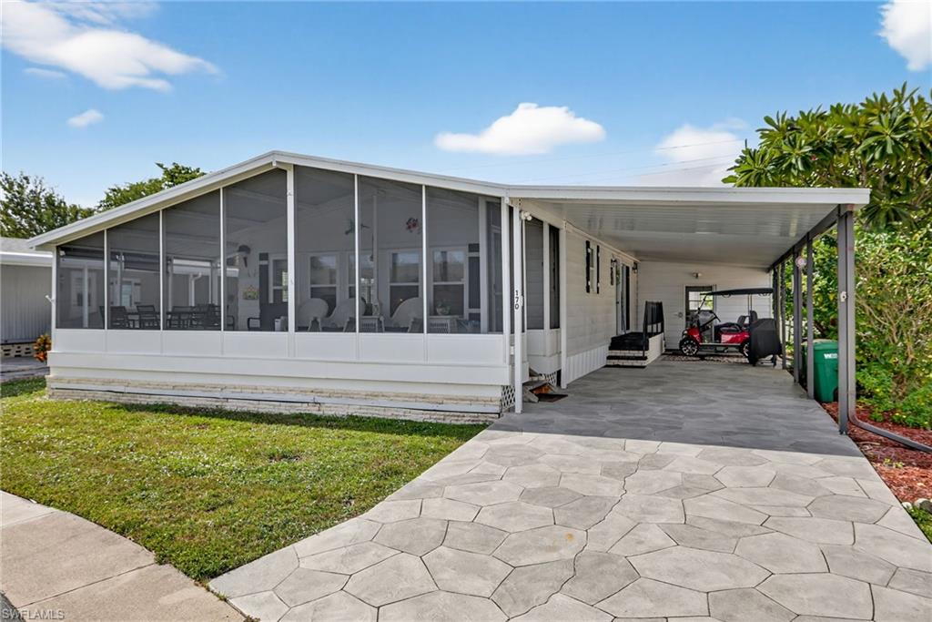 170 Oceans Boulevard, Unit 170 Naples, FL 34104 - Photo 35 of 36 a view of house with backyard outdoor seating and plants