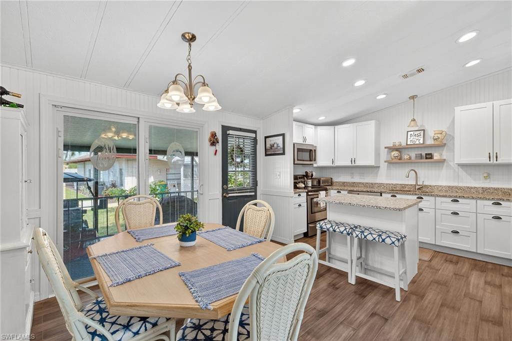 170 Oceans Boulevard, Unit 170 Naples, FL 34104 - Photo 4 of 36 a view of a dining room with furniture window and wooden floor