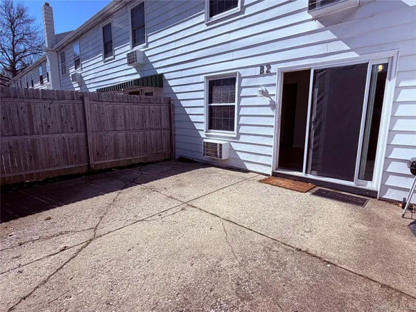 a view of backyard with small cabin and wooden fencing