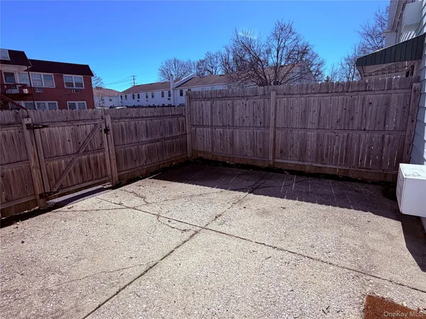 a view of a wooden fence with a bench in front of it