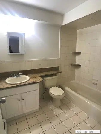a bathroom with a sink a toilet and bathtub