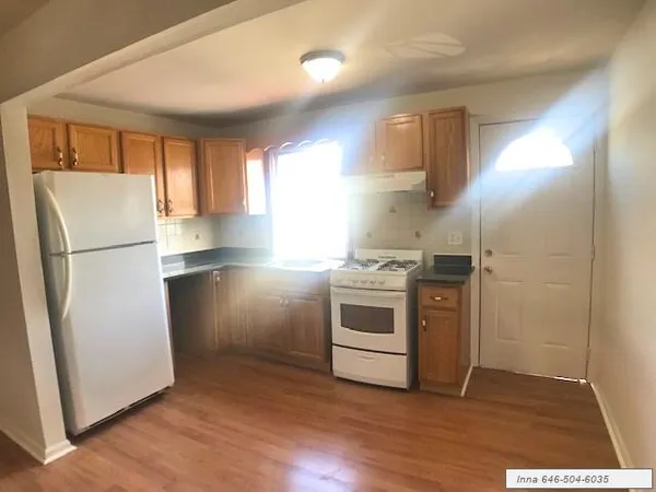 a kitchen with a refrigerator and a stove