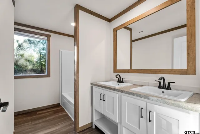 a bathroom with a double vanity sink and mirror