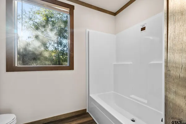 a bathroom with a bathtub and window