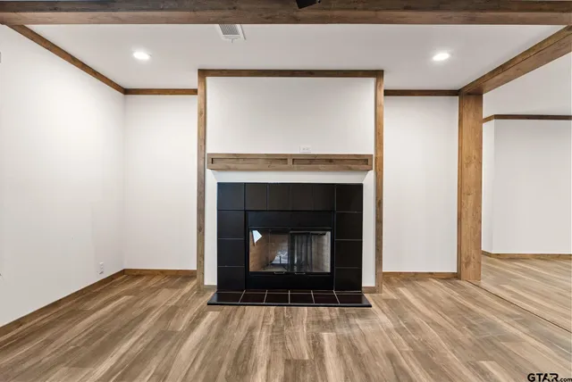 a room with fireplace and a wooden floor