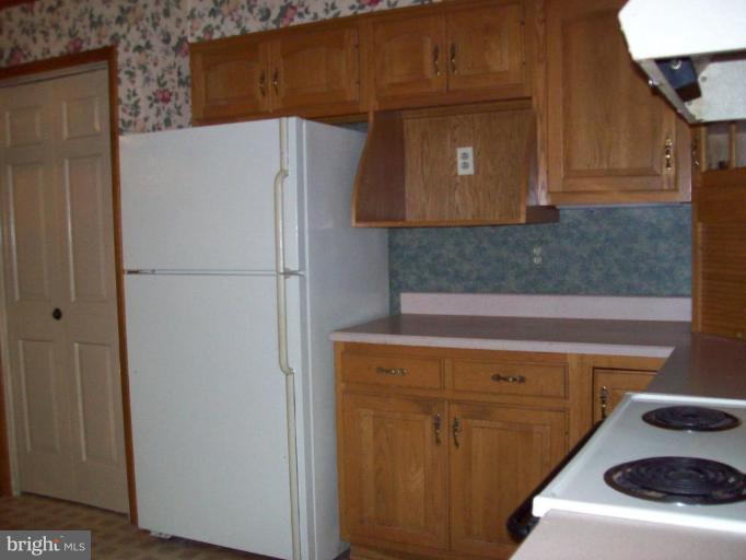 5025 Old Quarter Road Upperco, MD 21155 - Photo 15 of 18 a white refrigerator freezer and a stove sitting inside of a kitchen