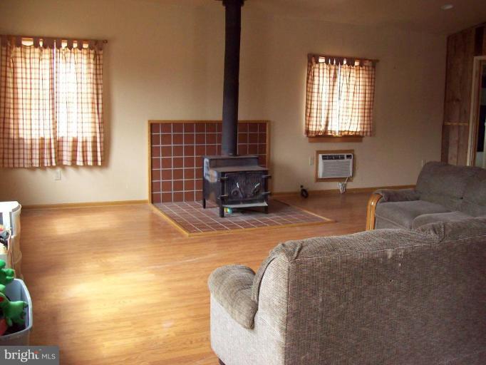 5025 Old Quarter Road Upperco, MD 21155 - Photo 7 of 18 a bedroom with a bed and wooden floor