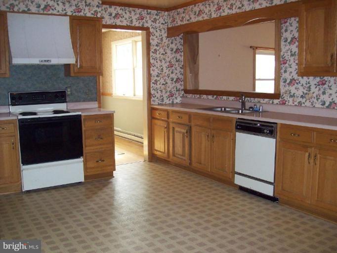5025 Old Quarter Road Upperco, MD 21155 - Photo 8 of 18 a kitchen with stainless steel appliances granite countertop a stove a sink and a microwave