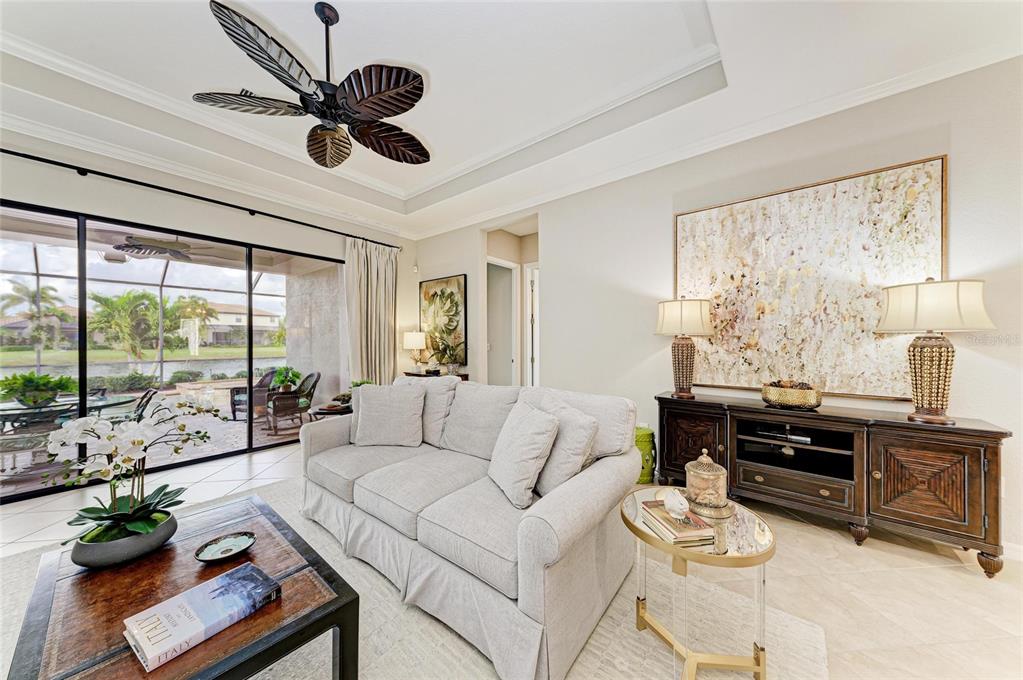 13117 Ramblewood Trail Lakewood Ranch, FL 34211 - Photo 15 of 76 a living room with furniture ceiling fan and a large window