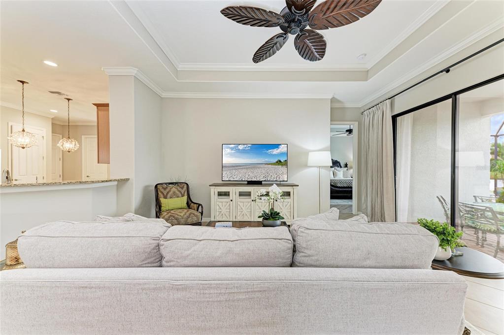 13117 Ramblewood Trail Lakewood Ranch, FL 34211 - Photo 16 of 76 a living room with furniture and a chandelier