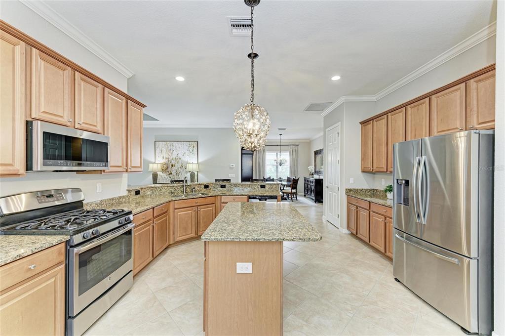 13117 Ramblewood Trail Lakewood Ranch, FL 34211 - Photo 26 of 76 a large kitchen with granite countertop a large counter top stainless steel appliances and cabinets