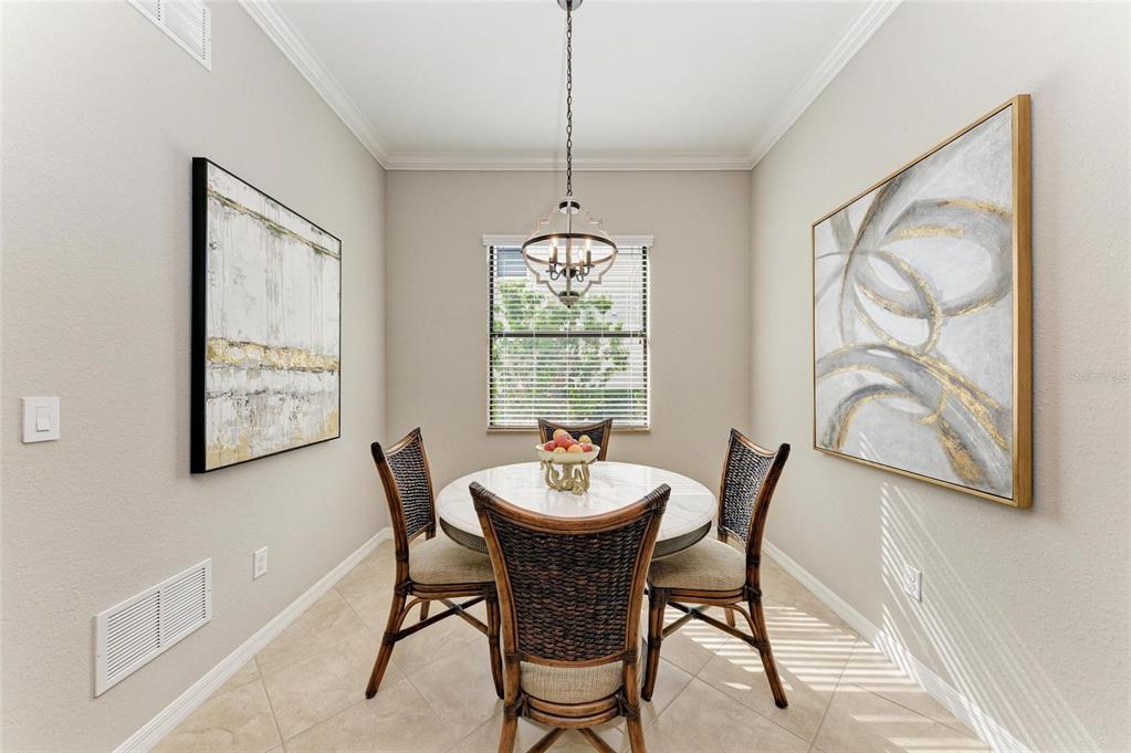 13117 Ramblewood Trail Lakewood Ranch, FL 34211 - Photo 29 of 76 a dining room with furniture a window and a chandelier