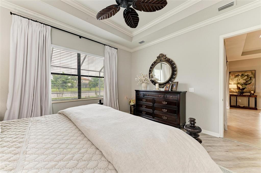 13117 Ramblewood Trail Lakewood Ranch, FL 34211 - Photo 32 of 76 a bedroom with a bed and a dresser