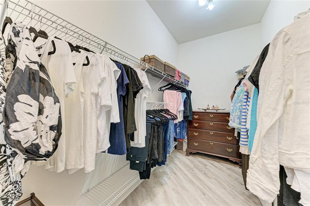 13117 Ramblewood Trail Lakewood Ranch, FL 34211 - Photo 37 of 76 a view of walk in closet with clothes and shoes