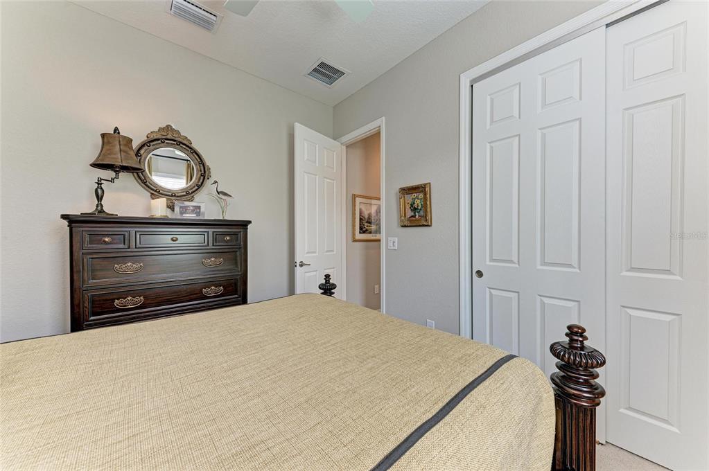 13117 Ramblewood Trail Lakewood Ranch, FL 34211 - Photo 42 of 76 a bedroom with a bed and a dresser