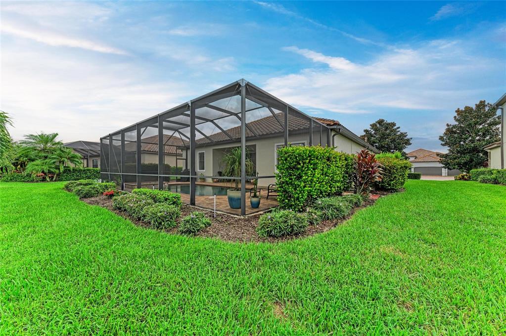 13117 Ramblewood Trail Lakewood Ranch, FL 34211 - Photo 56 of 76 a view of a house with a yard and plants