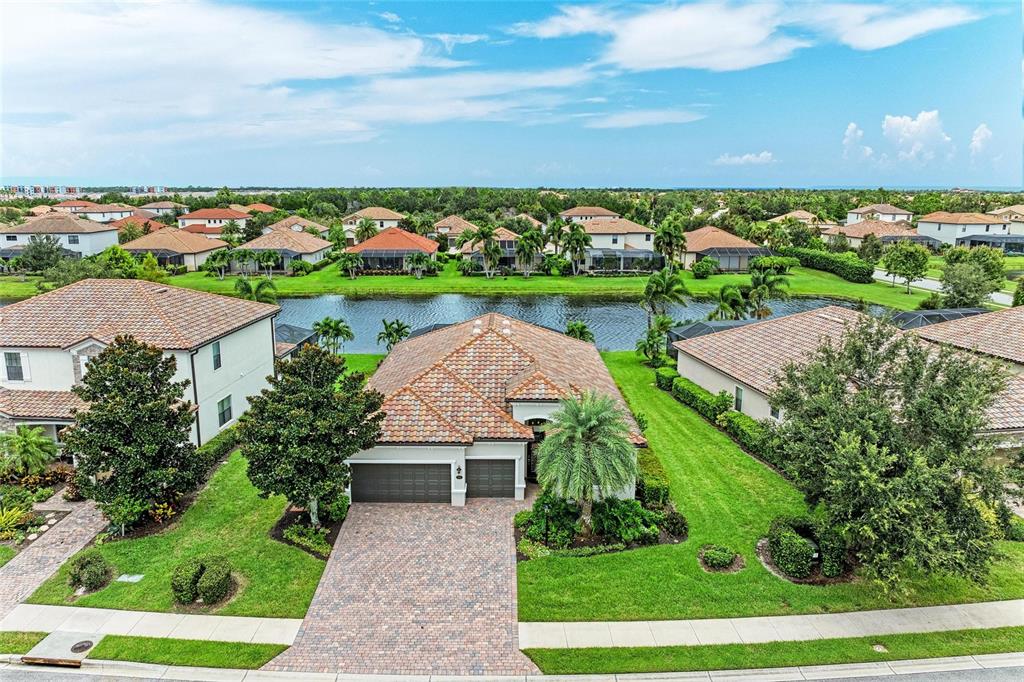 13117 Ramblewood Trail Lakewood Ranch, FL 34211 - Photo 60 of 76 an aerial view of a house with a garden and lake view