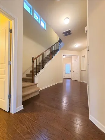 a view of entryway and hall with wooden floor