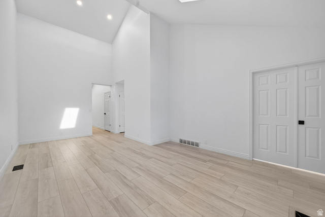 6969 South 855 East Midvale, UT 84047 - Photo 18 of 55 Spacious interior featuring soaring vaulted ceilings, recessed lighting, light wood-finish flooring, and white paneled doors