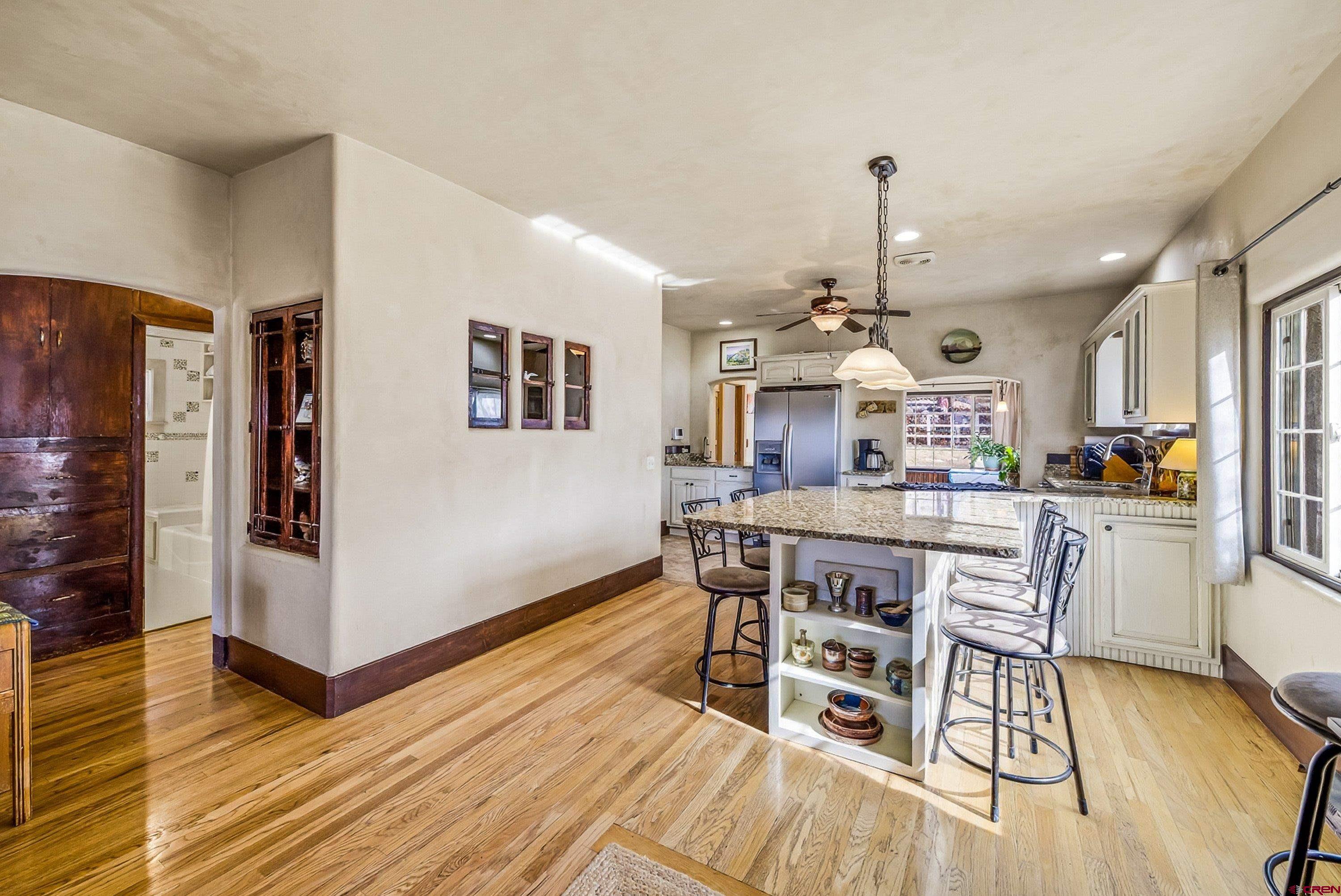 a view of a dining room with furniture wooden floor and chandelier