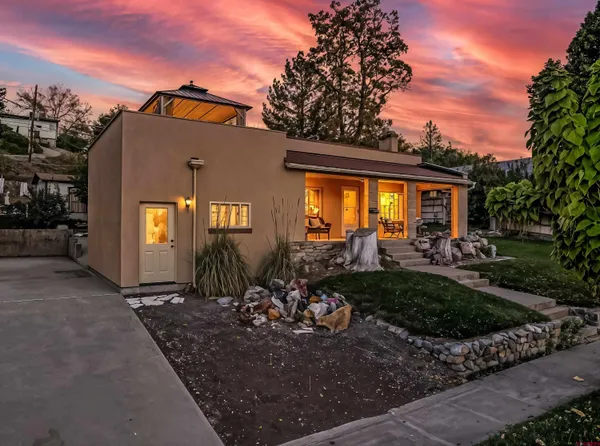 a living room with furniture a fireplace and kitchen view