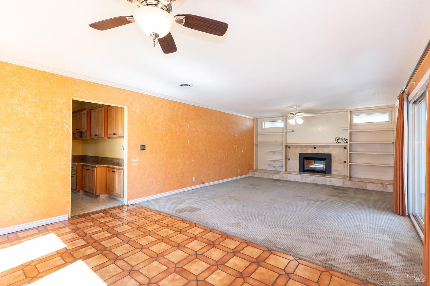 2236 West Hearn Avenue Santa Rosa, CA 95407 - Photo 14 of 56 a view of empty room with a fireplace and chandelier fan