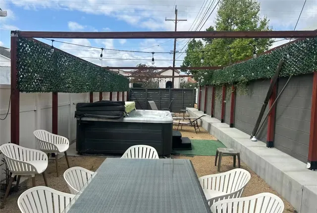 a view of a couches and dinning table and chairs in patio