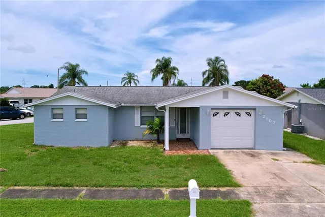 a front view of house with yard and green space