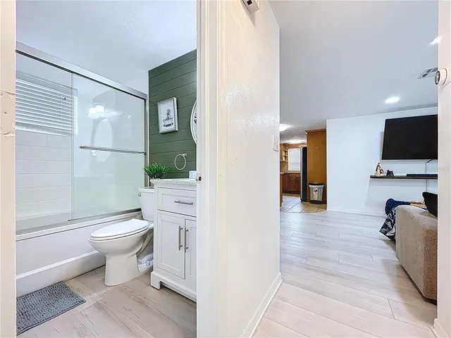 a bathroom with a toilet a sink and a mirror