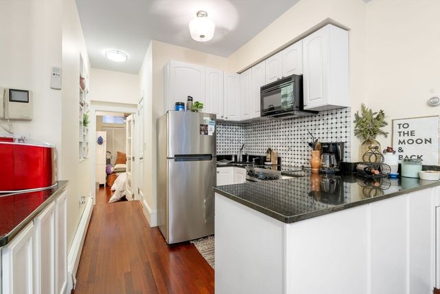 a kitchen with refrigerator a sink and a stove