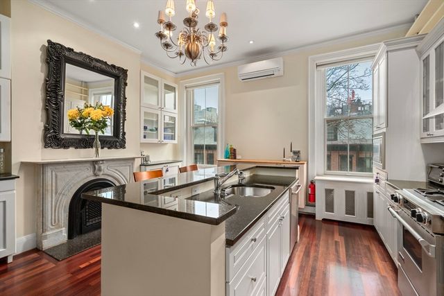 a kitchen that has a sink and a stove in it