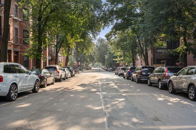 a view of a large building with a yard and plants