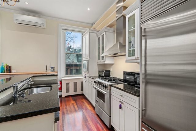 a kitchen with granite countertop a stove and a sink
