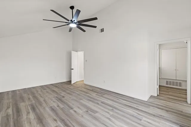 a view of an empty room with wooden floor