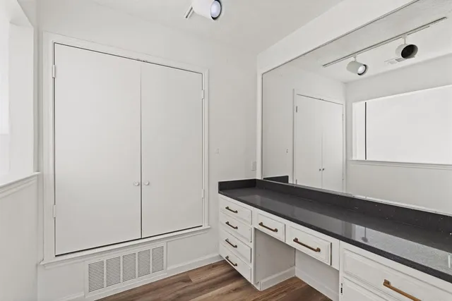a kitchen with granite countertop white cabinets and white appliances