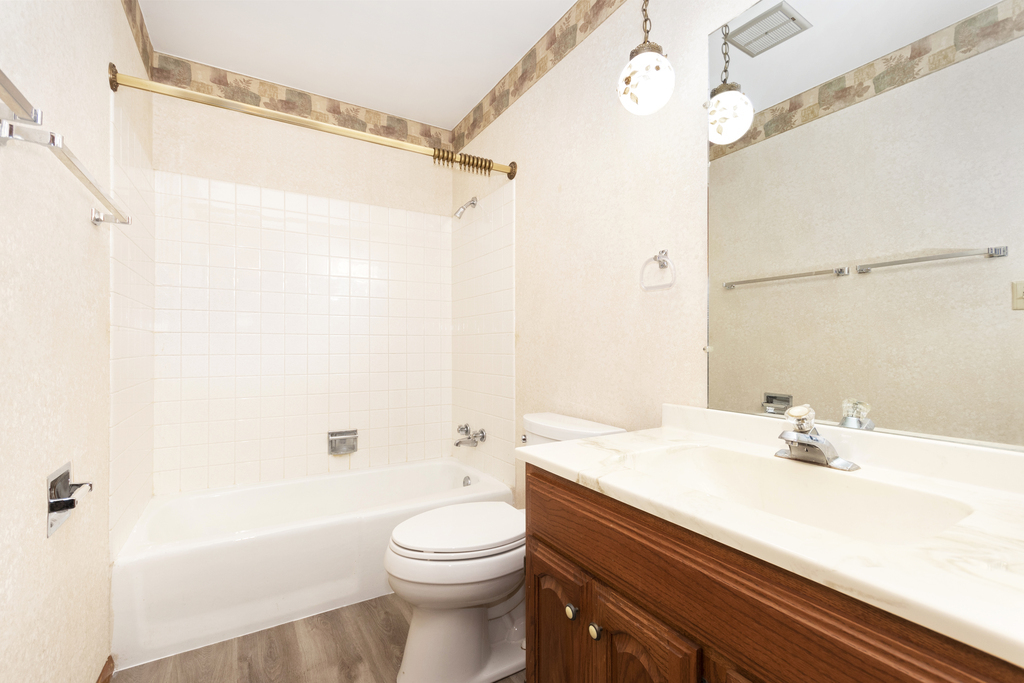 11 Woodcliff Road Montgomery, IL 60538 - Photo 13 of 18 a bathroom with a sink a toilet and shower