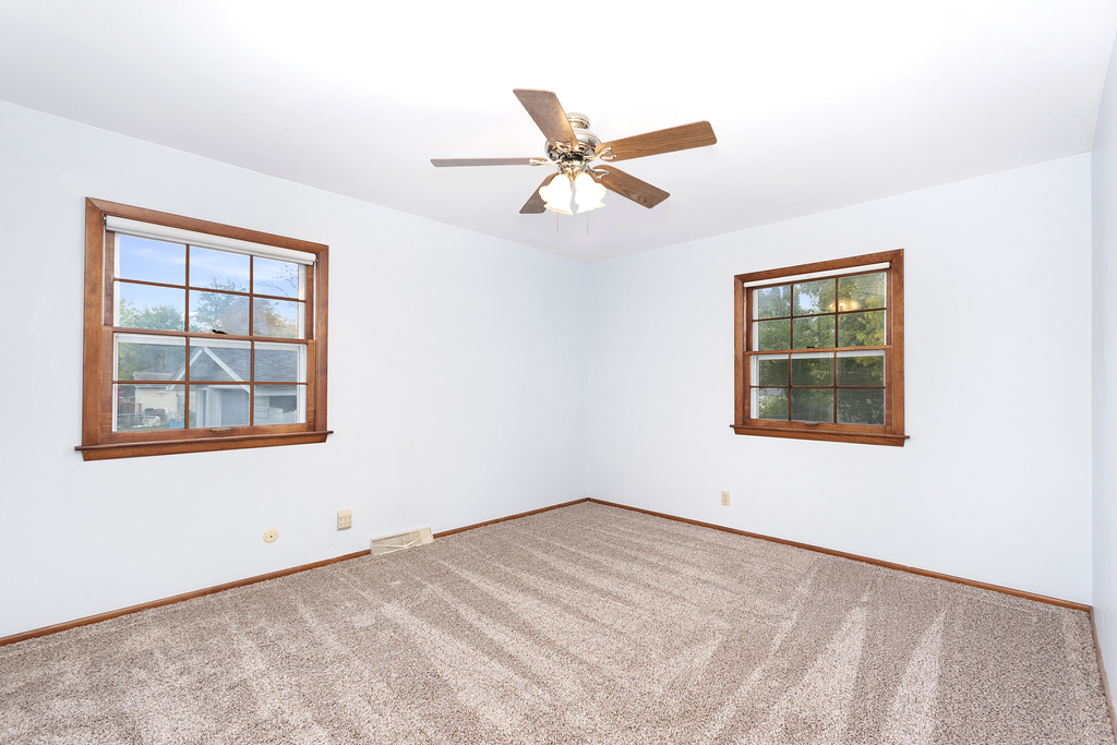 11 Woodcliff Road Montgomery, IL 60538 - Photo 9 of 18 an empty room with a window and a ceiling fan