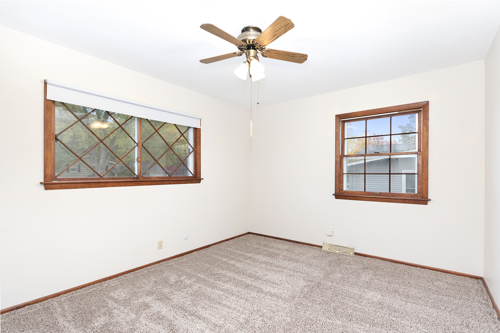 11 Woodcliff Road Montgomery, IL 60538 - Photo 10 of 18 an empty room with a window and a ceiling fan