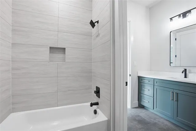 a bathroom with a bathtub and a sink