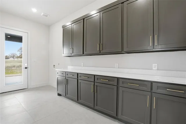a kitchen with stainless steel appliances granite countertop a sink and cabinets with wooden floor