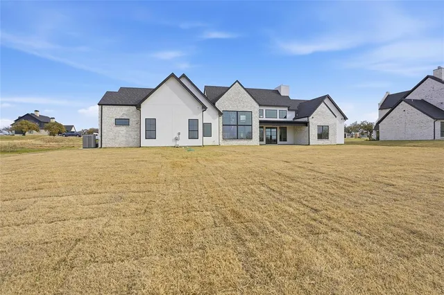 a view of house with yard and ocean view