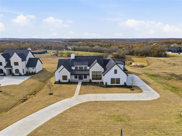 an aerial view of a house with a ocean view