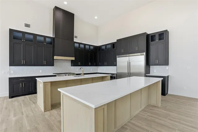a kitchen with stainless steel appliances a sink and a refrigerator
