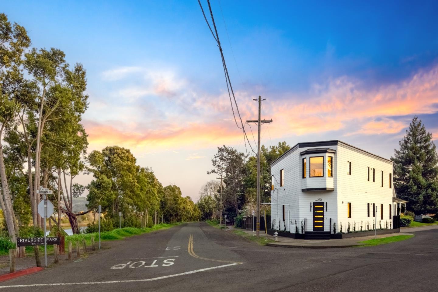 585 Riverside Drive Napa, CA 94559 - Photo 2 of 36 a view of a white house with a big yard and large trees