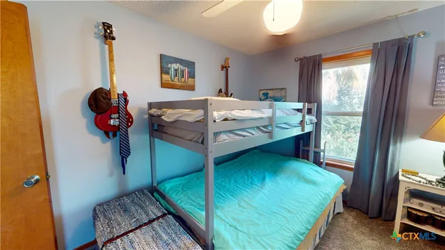 a bathroom with a granite countertop sink a mirror and shower