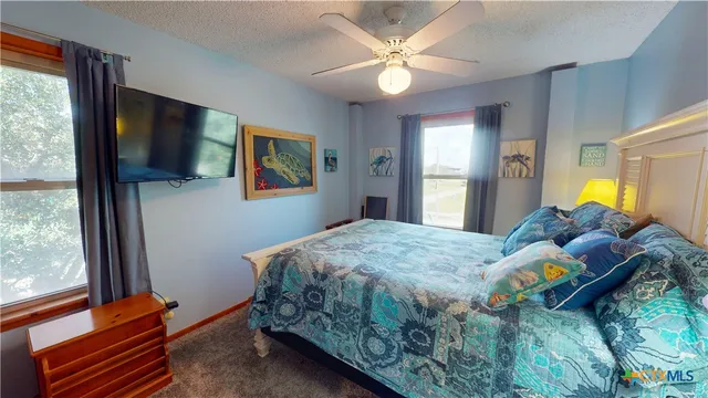 a bedroom with furniture and a large window