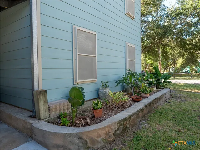 an aerial view of a house with a yard and plants