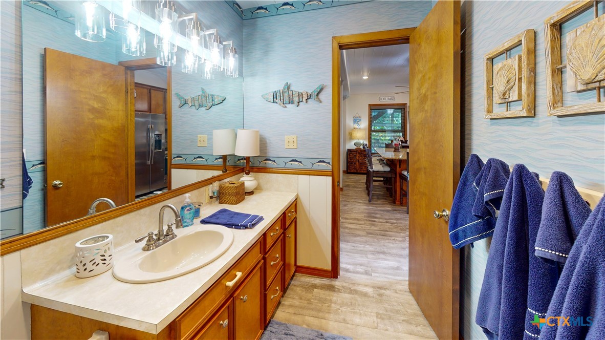 509 Monroe Avenue Port O'Connor, TX 77982 - Photo 42 of 46 a en suite bathroom with sink and mirror