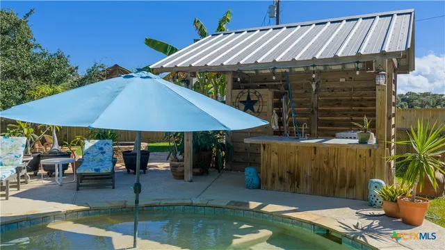 a bathroom with a granite countertop sink and a shower