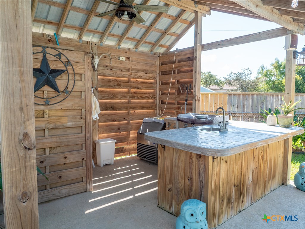 509 Monroe Avenue Port O'Connor, TX 77982 - Photo 8 of 46 a bathroom with a granite countertop sink and a shower